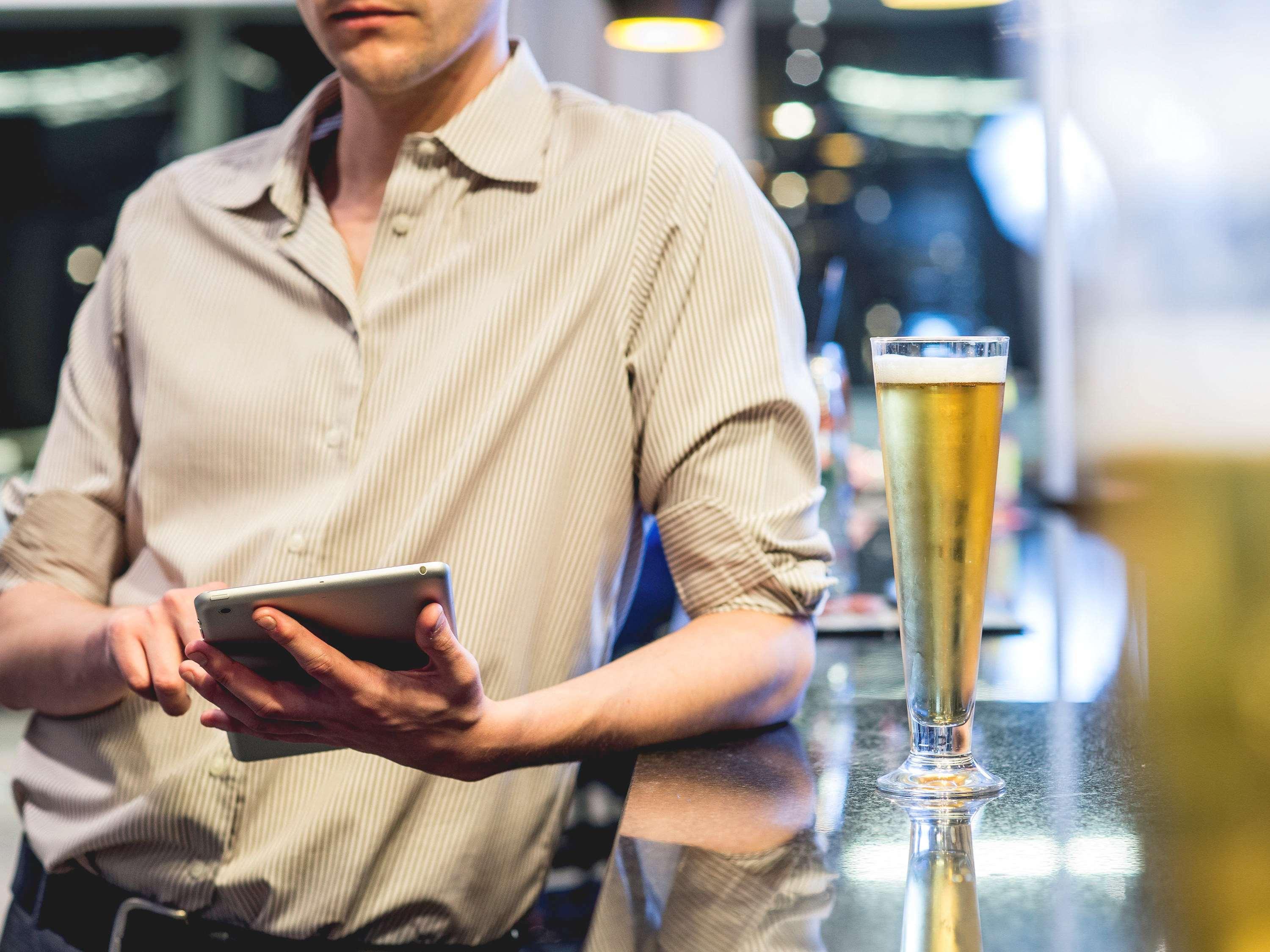 Pullman Santiago Vitacura Exterior photo A bartender using a tablet computer